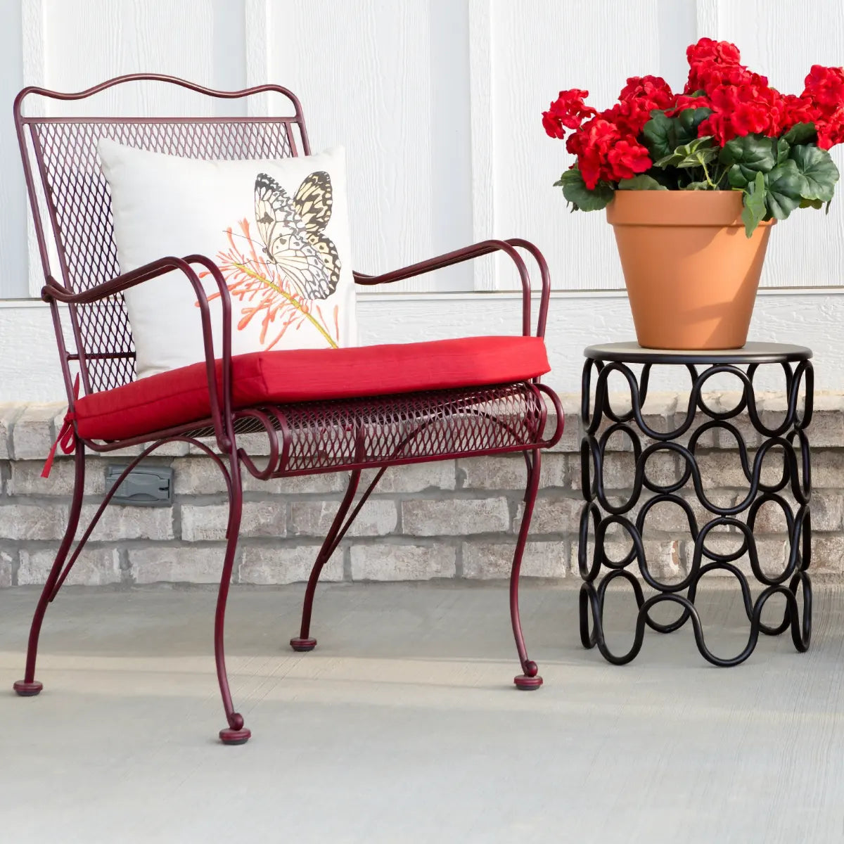 wrought iron patio furniture chair with red cushion